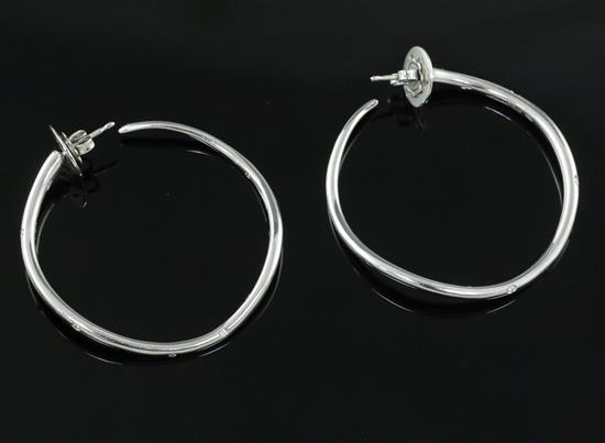 A modern pair of Italian Gavello 18ct white gold and five stone gypsy set diamond hoop earrings,